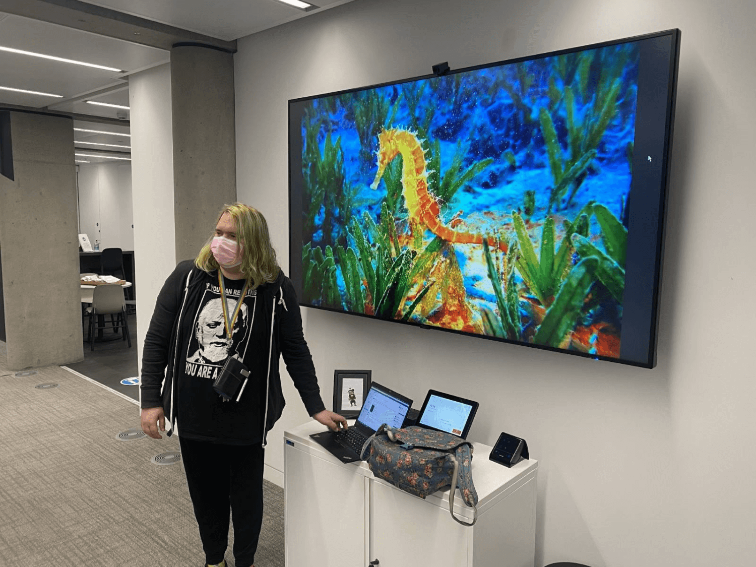 chee rabbits standing in front of a large screen displaying a seahorse